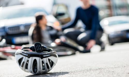 Bicycle Helmet and Injured Cyclist 